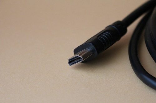 Black HDMI cable on brown surface