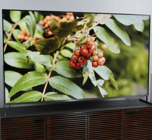 TCL 85R745 on brown tv cabinet