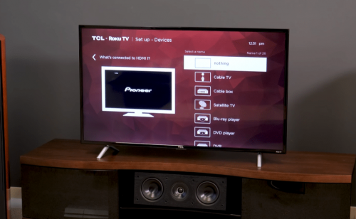 TCL TV on wooden cabinet