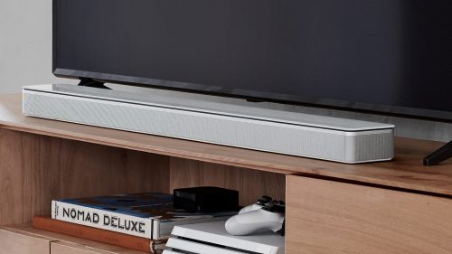 Bose Soundbar 700 in white beside a tv