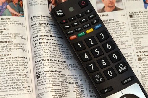 remote control placed on a TV guide