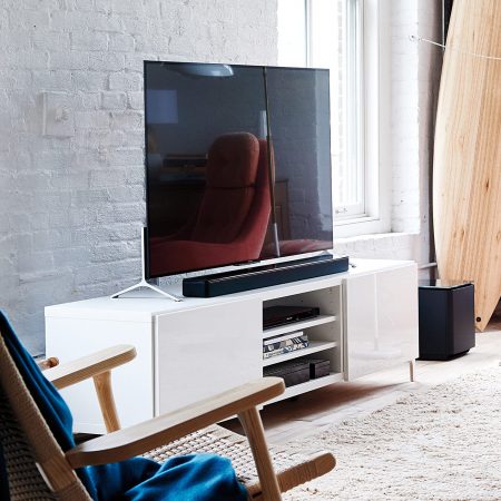 Bose SoundTouch 300 Soundbar above a living room table, baside a tv