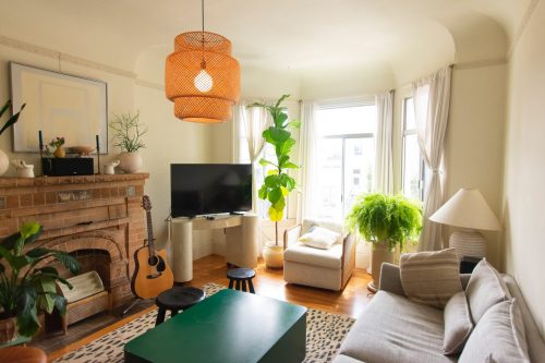 living room with guitar, green table, sofa and TV
